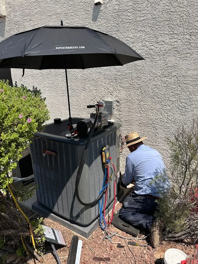 HVAC technician performing outdoor AC maintenance in Meridianville